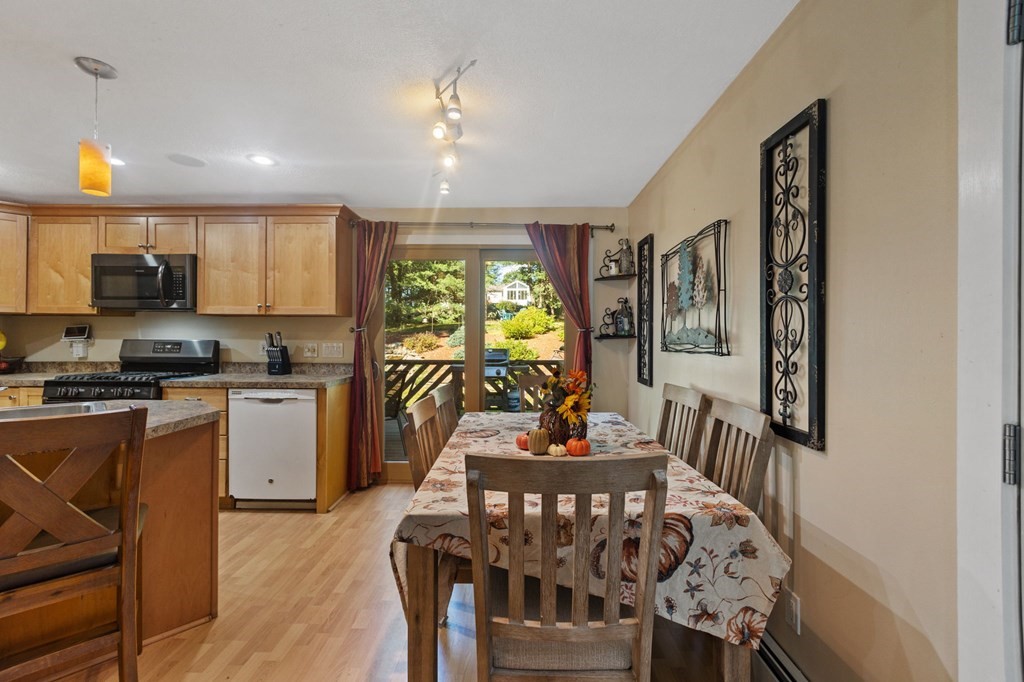 70 Colvintown Road Coventry, RI 02816 - Photo 9 of 41 a kitchen with stainless steel appliances granite countertop a stove a refrigerator a kitchen island and chairs in it