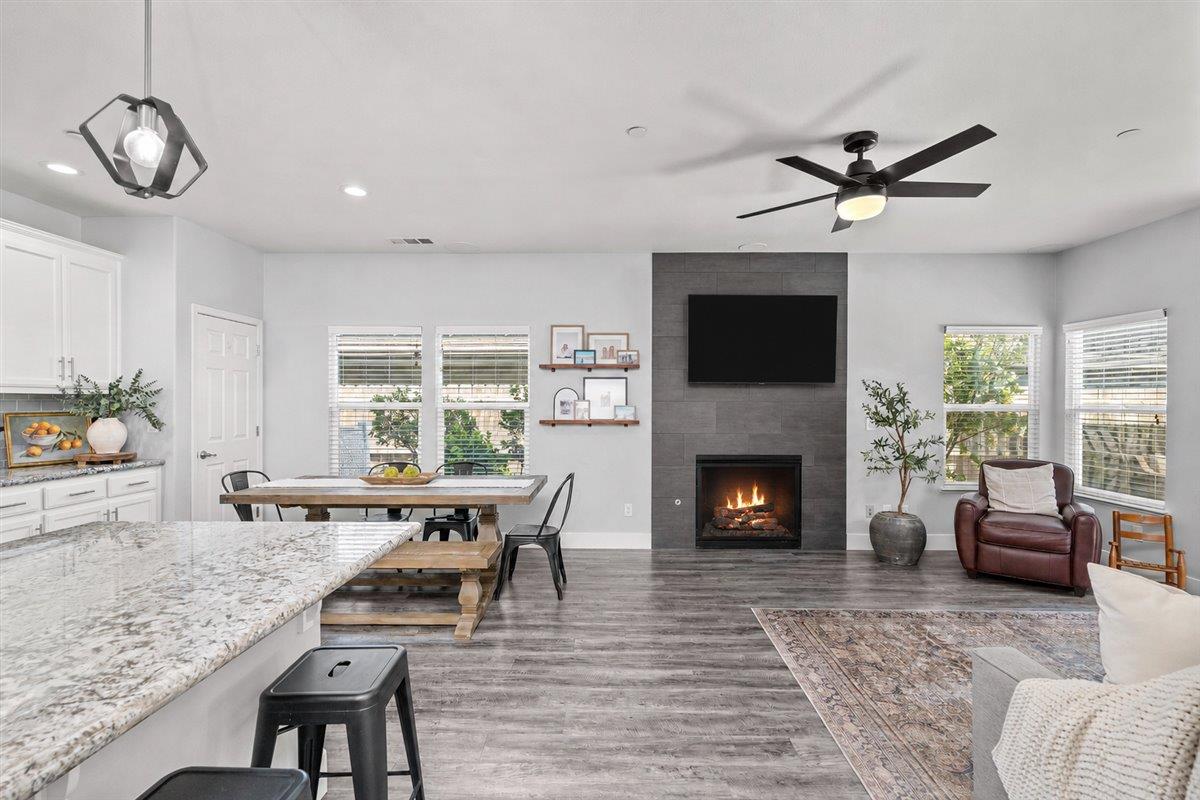 437 Silver Ridge Court Oakdale, CA 95361 - Photo 17 of 41 a living room with furniture a fireplace and a flat screen tv