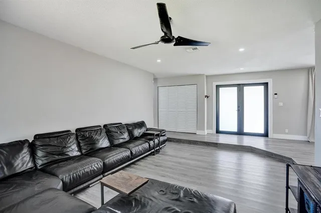 a living room with furniture and wooden floor