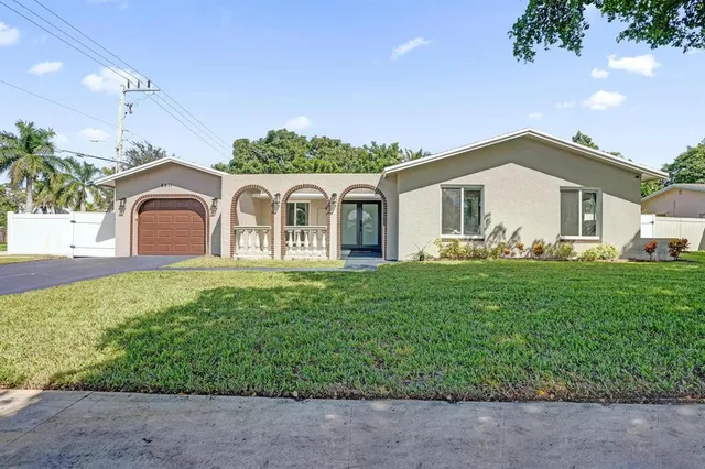 a front view of a house with a garden