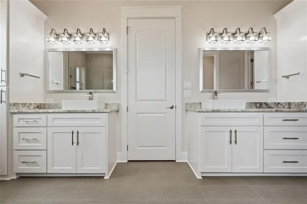 a kitchen with granite countertop white cabinets and wooden floor