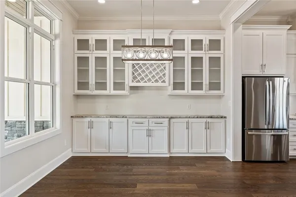 a large kitchen with stainless steel appliances granite countertop a stove a sink and a refrigerator