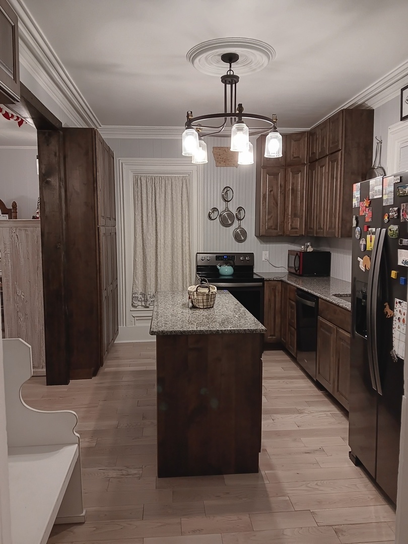 509 South Madison Street Morrison, IL 61270 - Photo 26 of 43 a kitchen with stainless steel appliances granite countertop a sink and a refrigerator