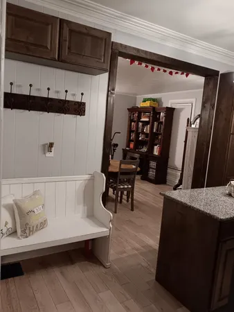 a view of a kitchen area with furniture and wooden floor