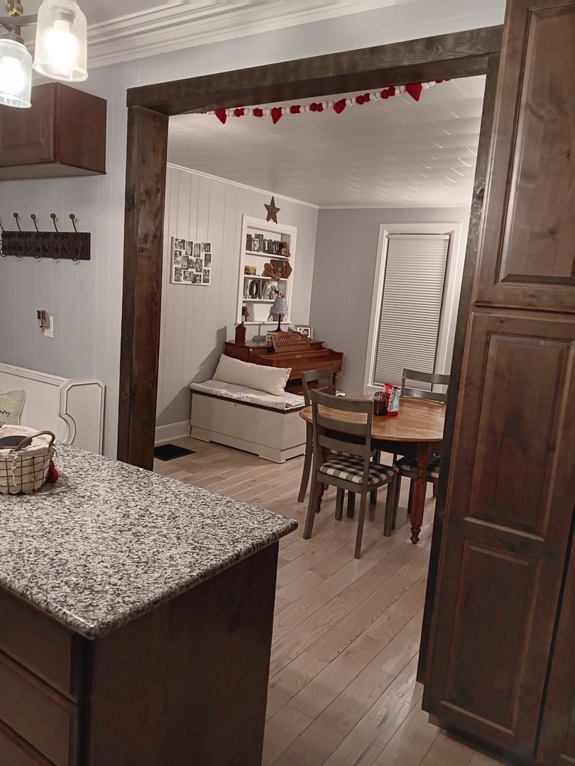 509 South Madison Street Morrison, IL 61270 - Photo 28 of 43 a view of a kitchen area with furniture and wooden floor