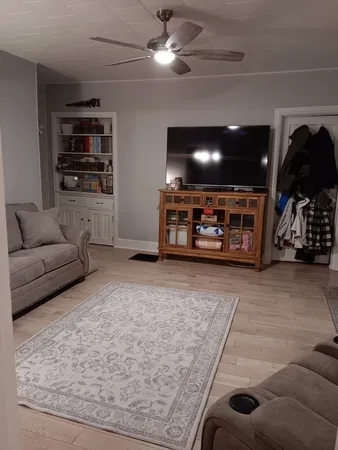 a living room with furniture and a rug