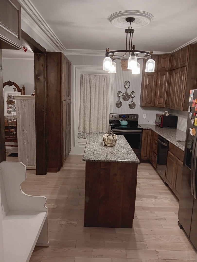 509 South Madison Street Morrison, IL 61270 - Photo 35 of 43 a kitchen with stainless steel appliances granite countertop a sink and a refrigerator