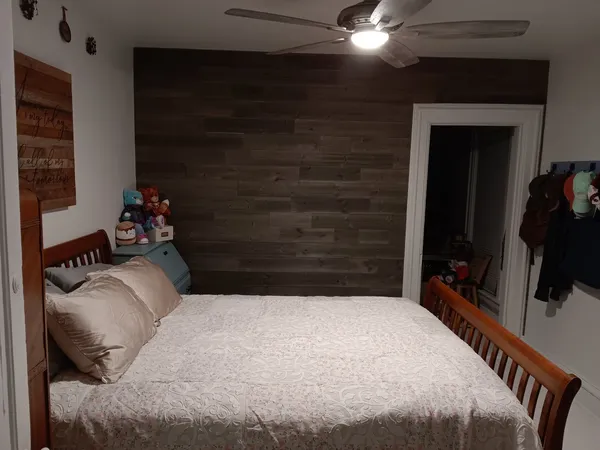 a bedroom with a bed and a potted plant