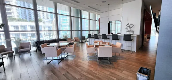 a living room with furniture a large window and a flat screen tv