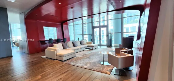 a living room with furniture and a large window