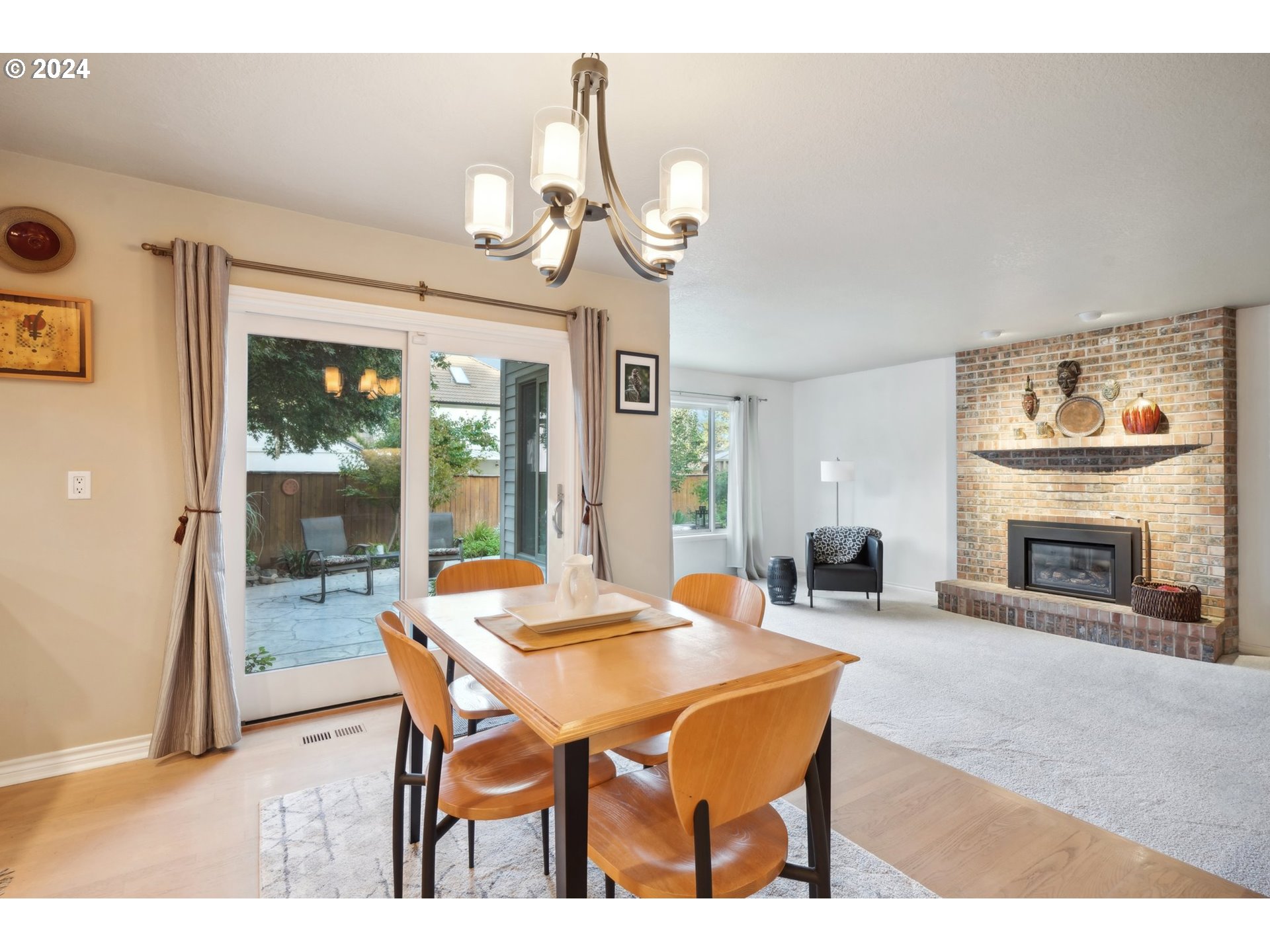 8121 Northeast 71st Loop Vancouver, WA 98662 - Photo 12 of 44 a dining room with wooden floor a chandelier a wooden table and chairs