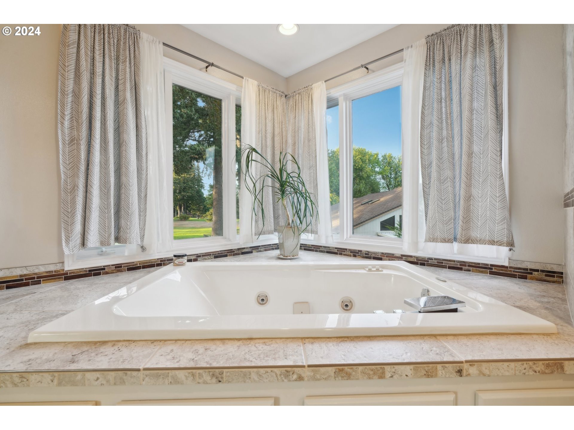 8121 Northeast 71st Loop Vancouver, WA 98662 - Photo 28 of 44 a white bath tub sitting in front of a window