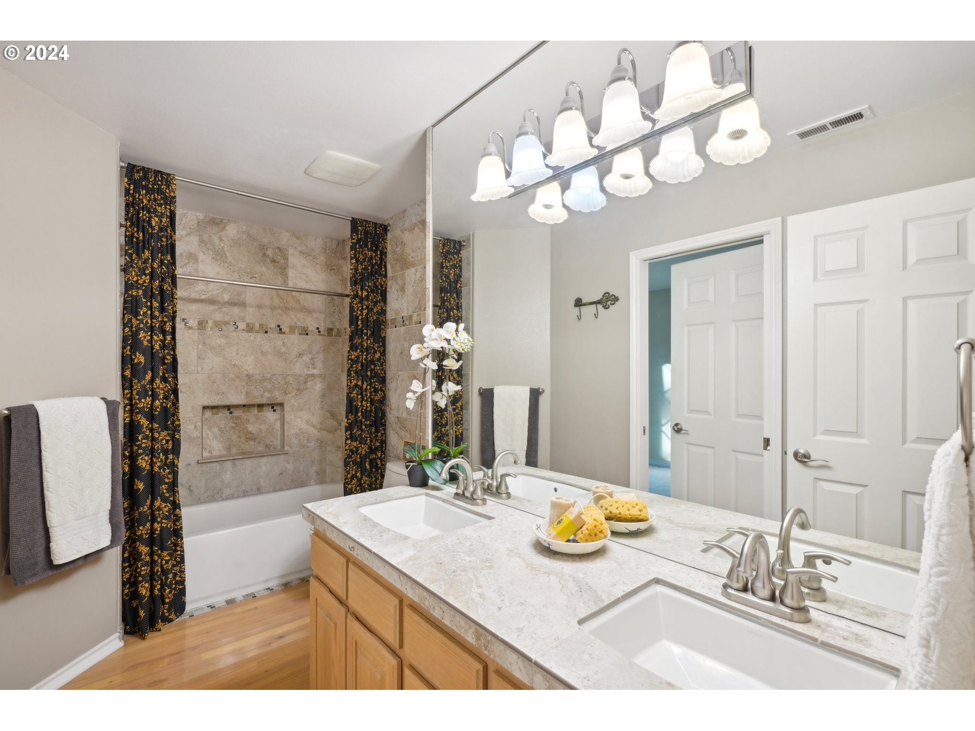 8121 Northeast 71st Loop Vancouver, WA 98662 - Photo 31 of 44 a bathroom with a granite countertop sink a large mirror and a shower
