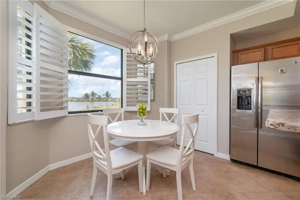 a dining room with furniture a chandelier and window