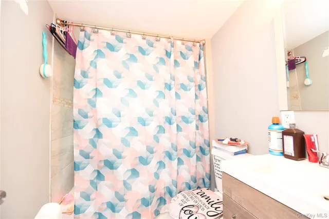 a bedroom with a bed and a curtain