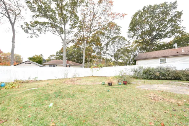 a view of yard with large trees