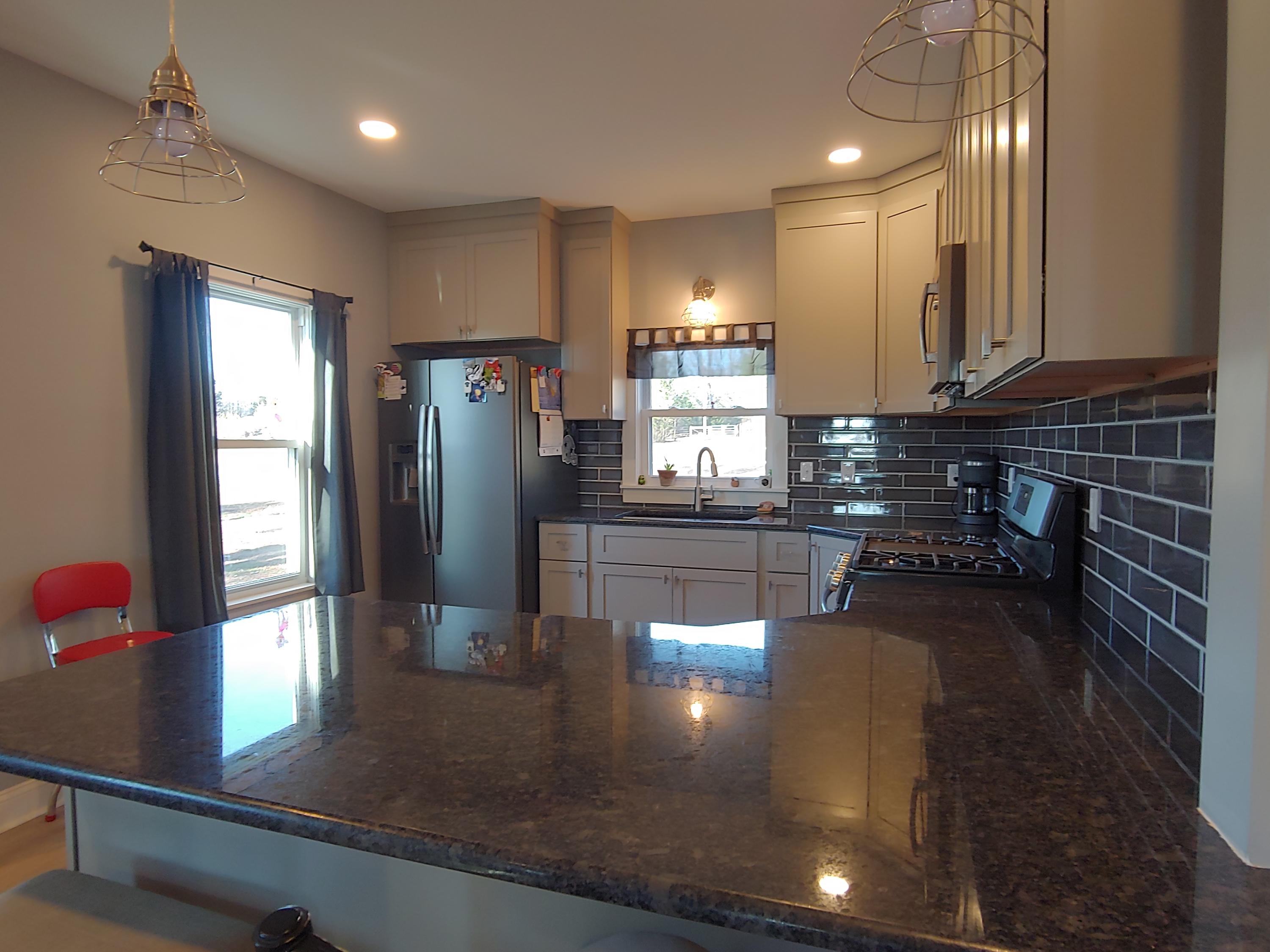 1016 Lacks Town Road Clover, VA 24534 - Photo 17 of 30 a kitchen with stainless steel appliances granite countertop a refrigerator a sink a stove and a counter top space