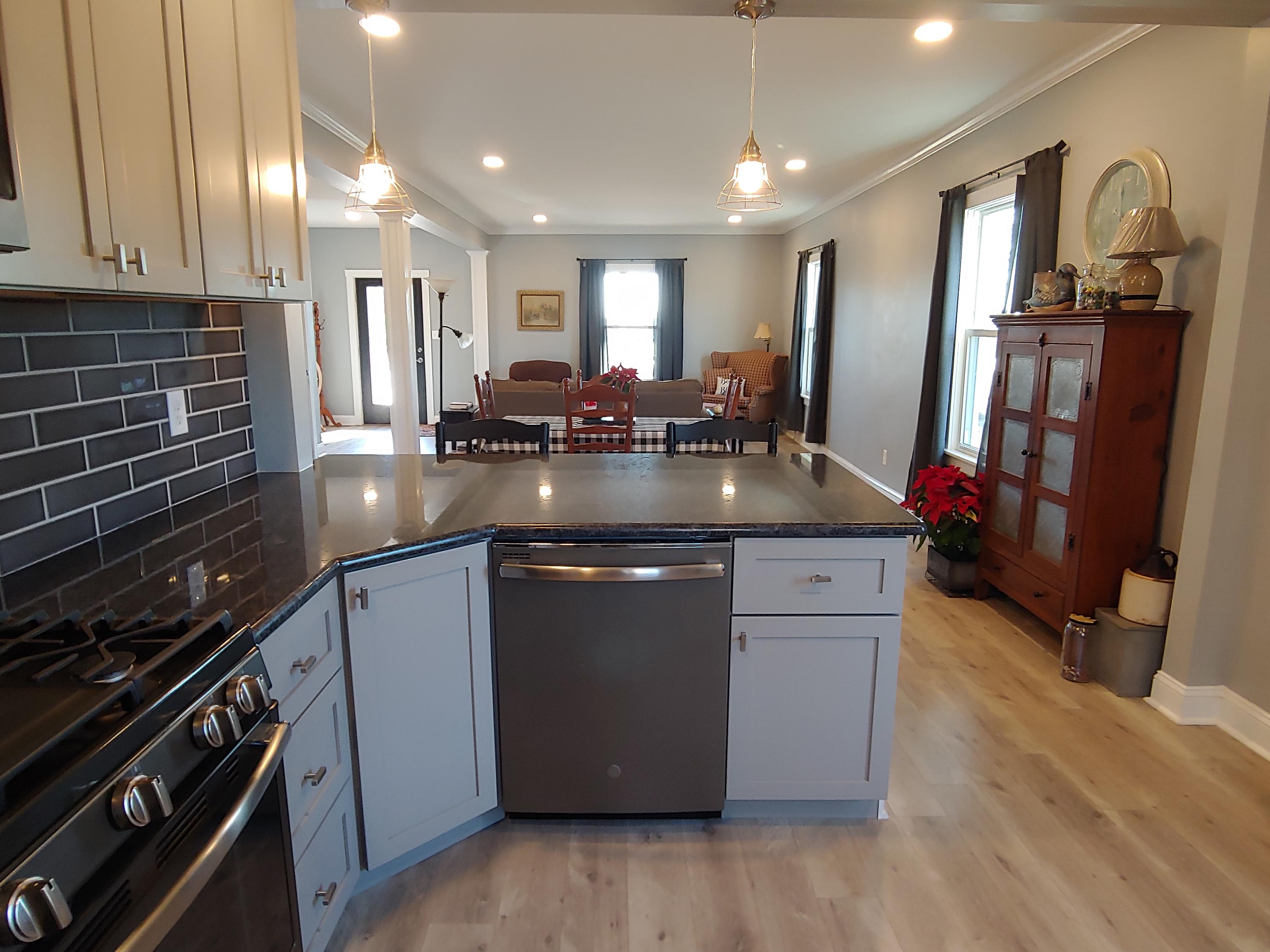 1016 Lacks Town Road Clover, VA 24534 - Photo 18 of 30 a kitchen with stainless steel appliances granite countertop a sink stove and cabinets
