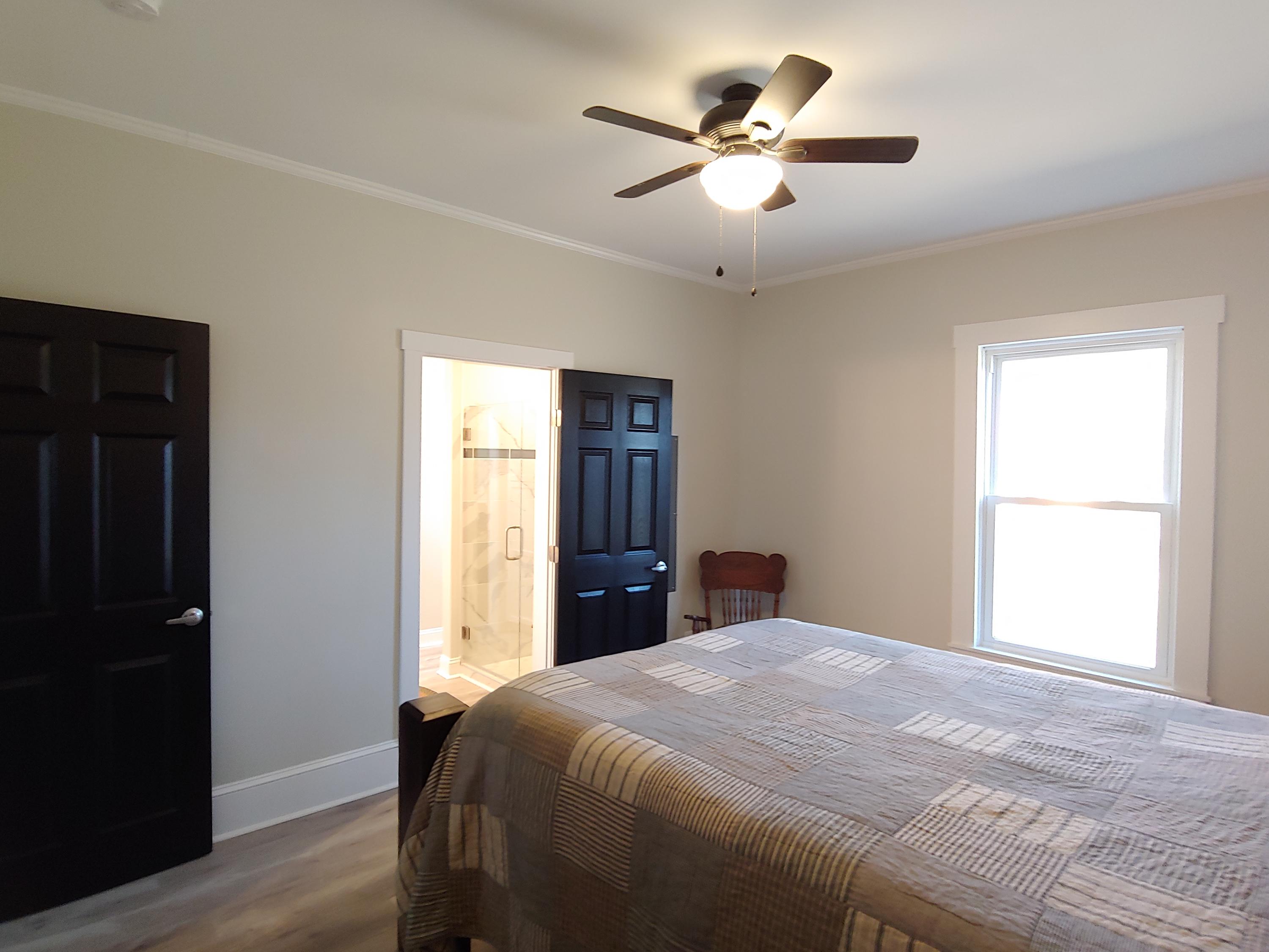 1016 Lacks Town Road Clover, VA 24534 - Photo 19 of 30 a bedroom with a large bed and a chandelier