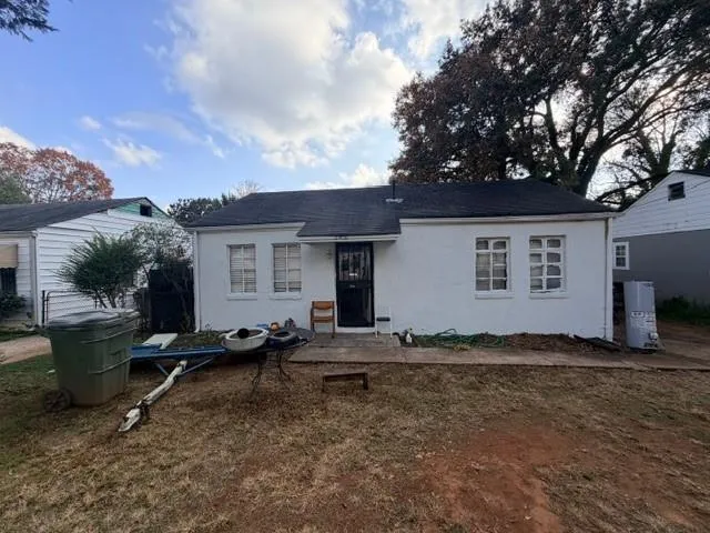 a backyard of a house with table and chairs