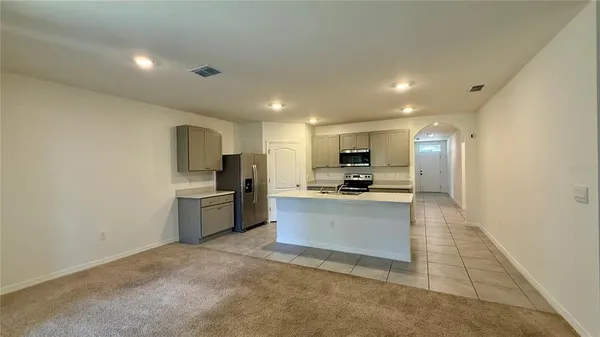 a kitchen with a refrigerator and a sink