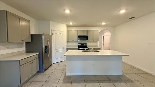 a kitchen with stainless steel appliances granite countertop a sink counter space and cabinets