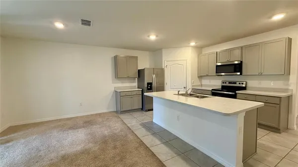 a kitchen with a sink a stove top oven and white kitchen