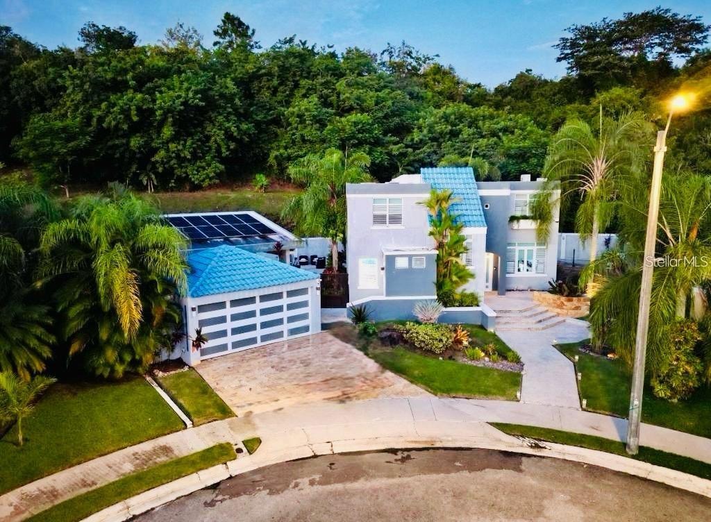 27 A Street Luquillo, PR 00773 - Photo 1 of 1 an aerial view of a house with swimming pool garden and patio