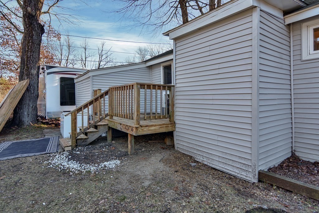 3 Helens Avenue Rutland, MA 01543 - Photo 8 of 28 a side of a house with a small yard and wooden fence