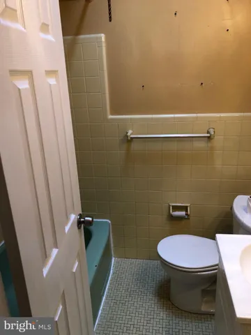 a bathroom with a sink a toilet and a shower