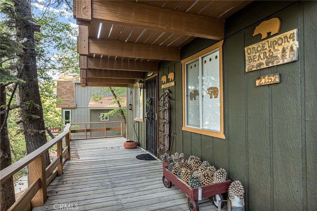a view of a porch with wooden floor and outdoor space
