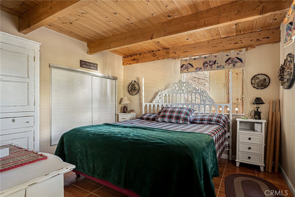 2151 Tank Road Running Springs, CA 92382 - Photo 18 of 29 a bedroom with a bed and a table