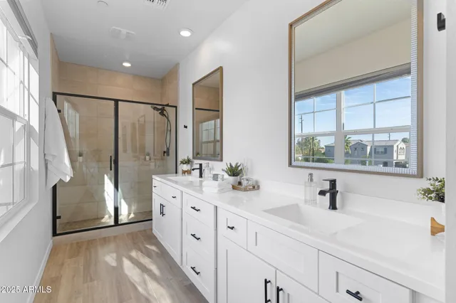 a bathroom with a tub sink shower and mirror