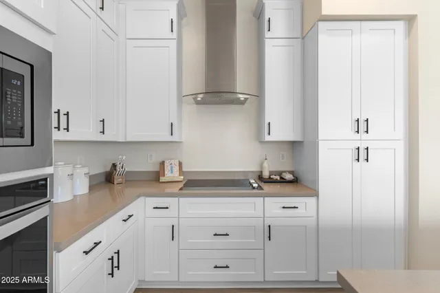 a kitchen with stainless steel appliances granite countertop a sink stove and cabinets