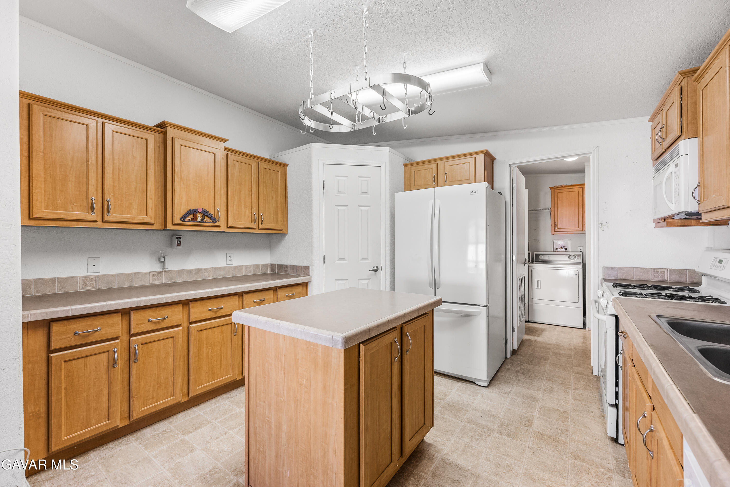 600 Dennison Road Tehachapi, CA 93561 - Photo 13 of 43 a kitchen that has a lot of cabinets in it with stainless steel appliances granite countertop a stove and a sink