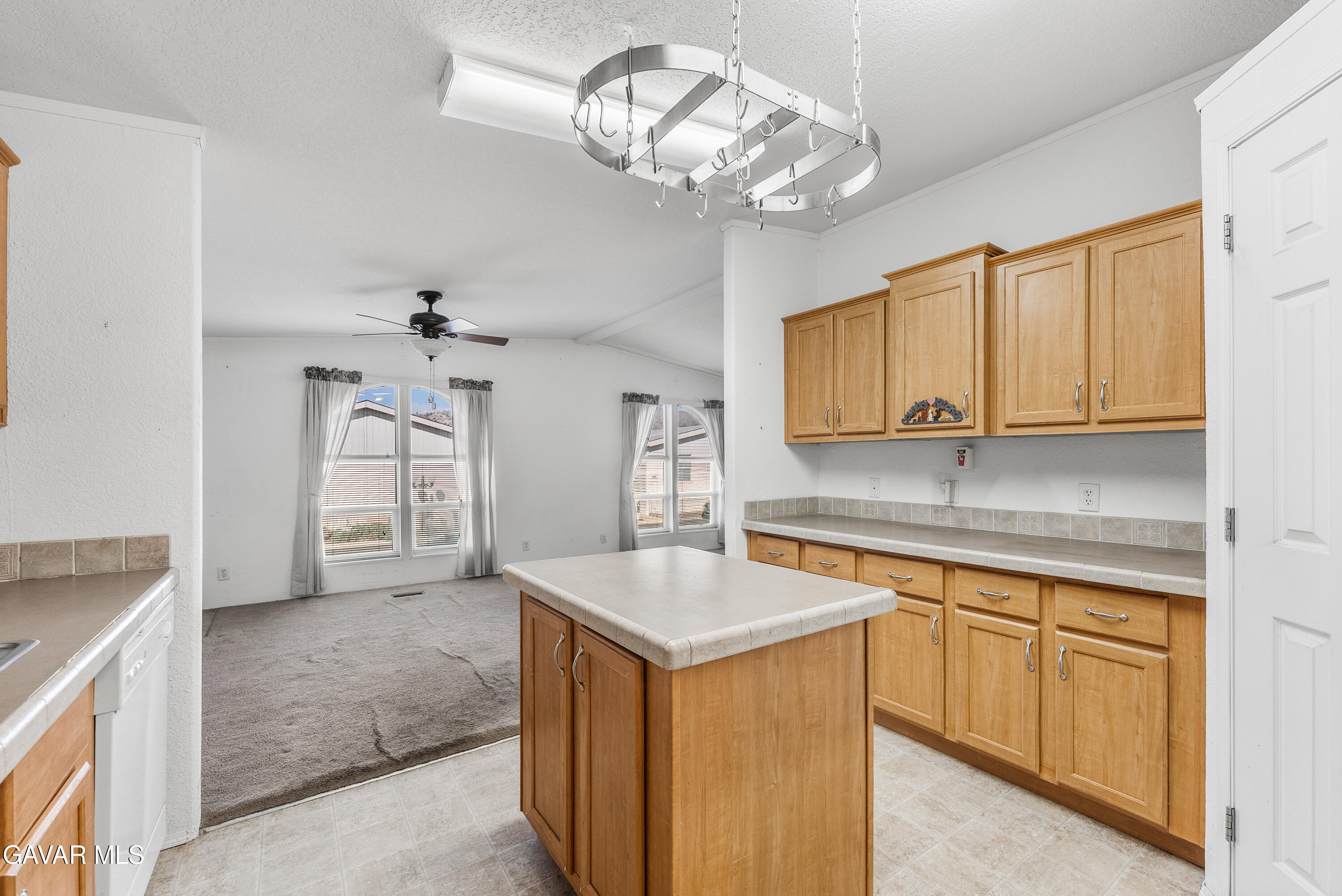 600 Dennison Road Tehachapi, CA 93561 - Photo 17 of 43 a kitchen with cabinets a chandelier and stainless steel appliances