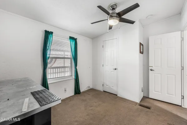 a view of livingroom with hardwood floor and a ceiling fan