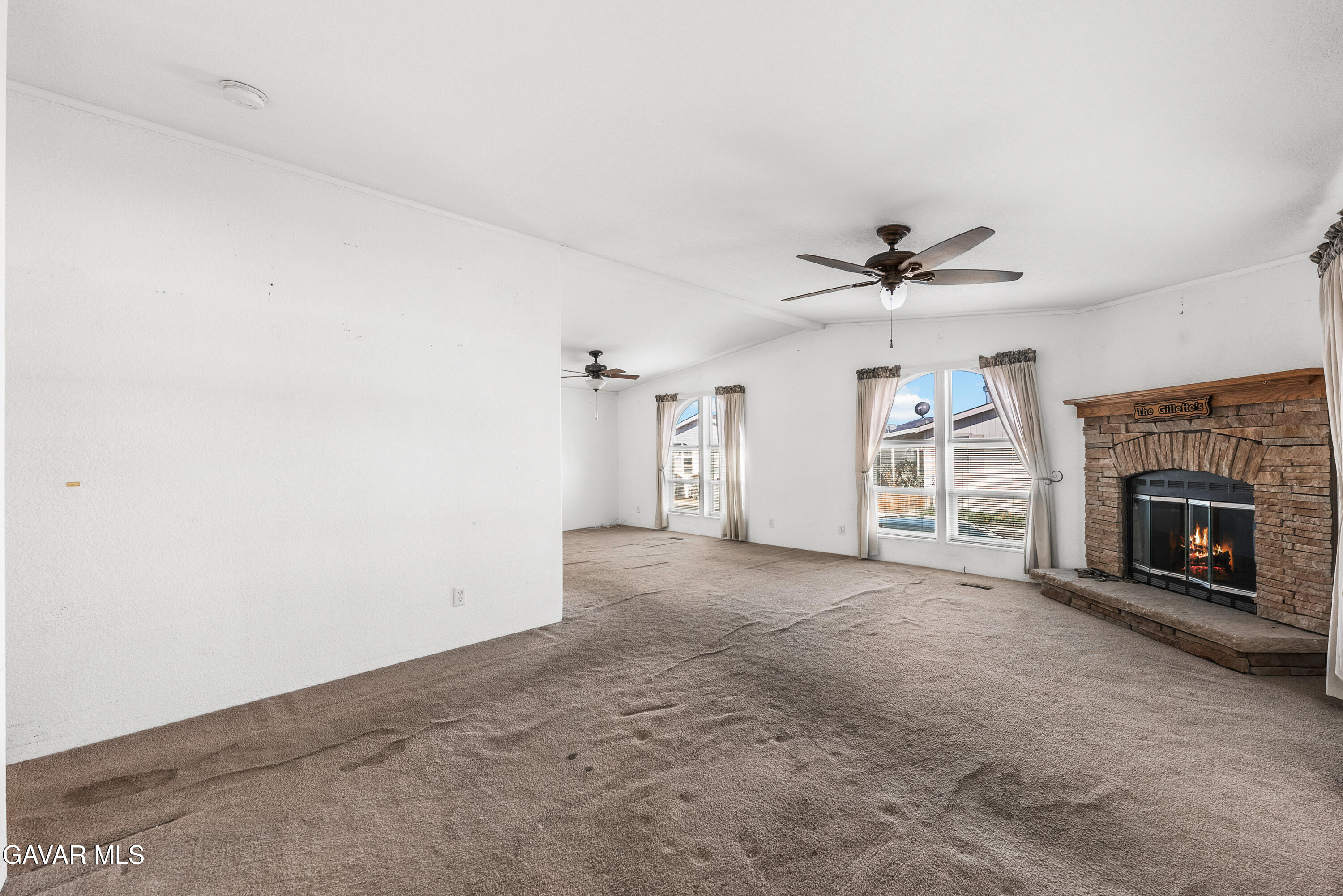 600 Dennison Road Tehachapi, CA 93561 - Photo 4 of 43 a view of a livingroom with a fireplace and a ceiling fan