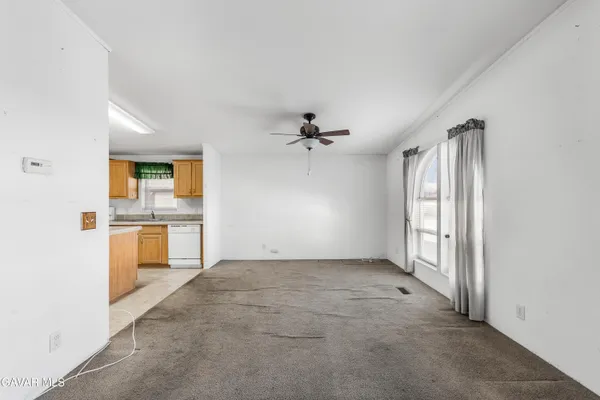 an empty room with a kitchen and a sink