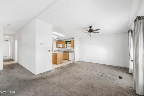 a view of a kitchen with a sink and a refrigerator