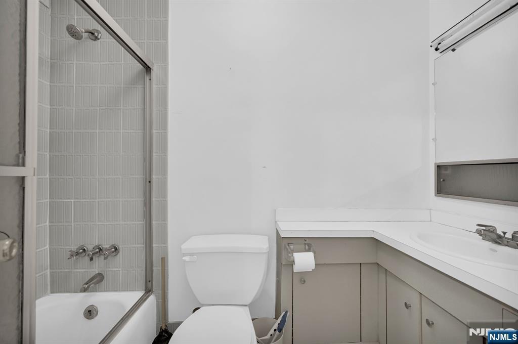 280 Prospect Avenue, Unit 3N Hackensack, NJ 07601 - Photo 16 of 23 a bathroom with a sink a toilet and shower