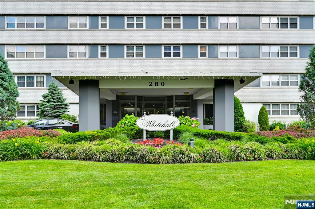 280 Prospect Avenue, Unit 3N Hackensack, NJ 07601 - Photo 2 of 23 a front view of a building with a garden and plants