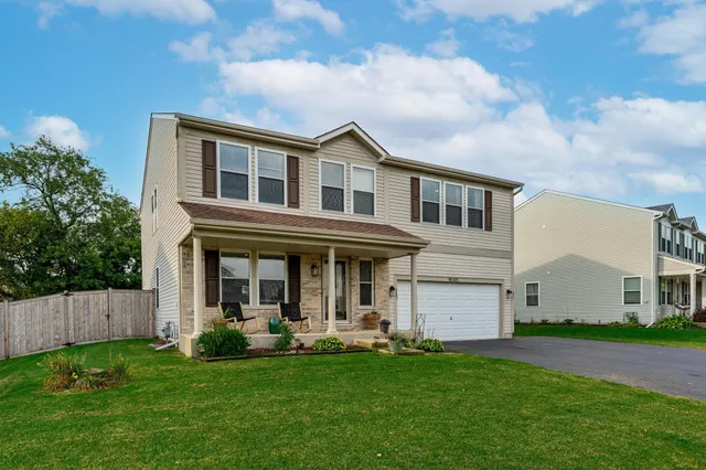 a view of a house with a swimming pool and a yard