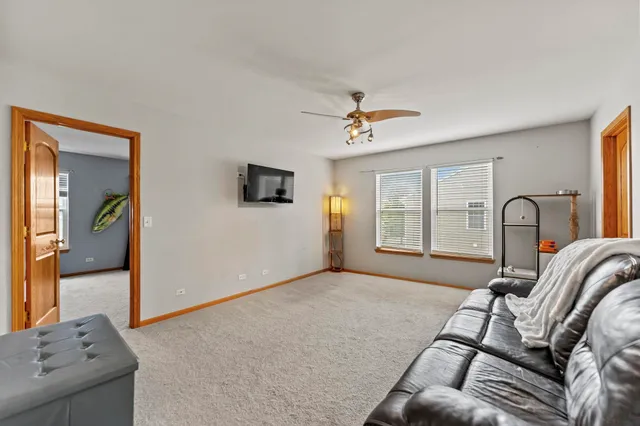a spacious bedroom with a bed and a chandelier