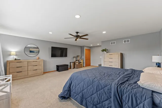 a large bathroom with a tub sink and mirror