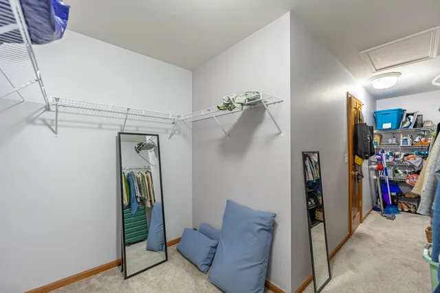 a spacious bedroom with a bed and a chandelier