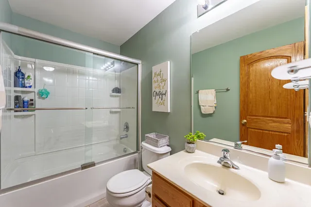 a view of a tiny house with a yard and sitting area