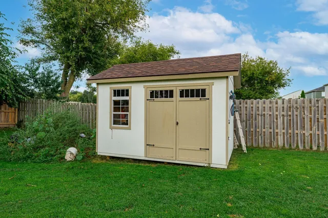 an aerial view of a house with outdoor space patio and trees all around