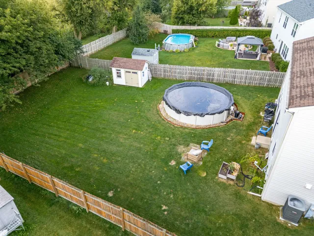 an aerial view of a house with garden space lake view and mountain view in back