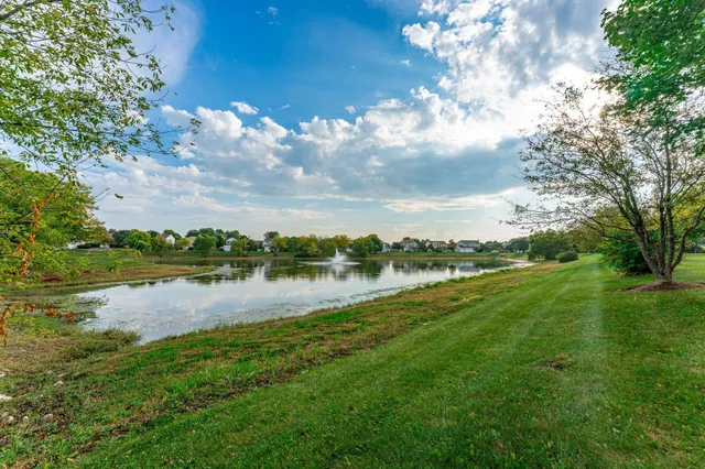 a view of a lake with houses in the background